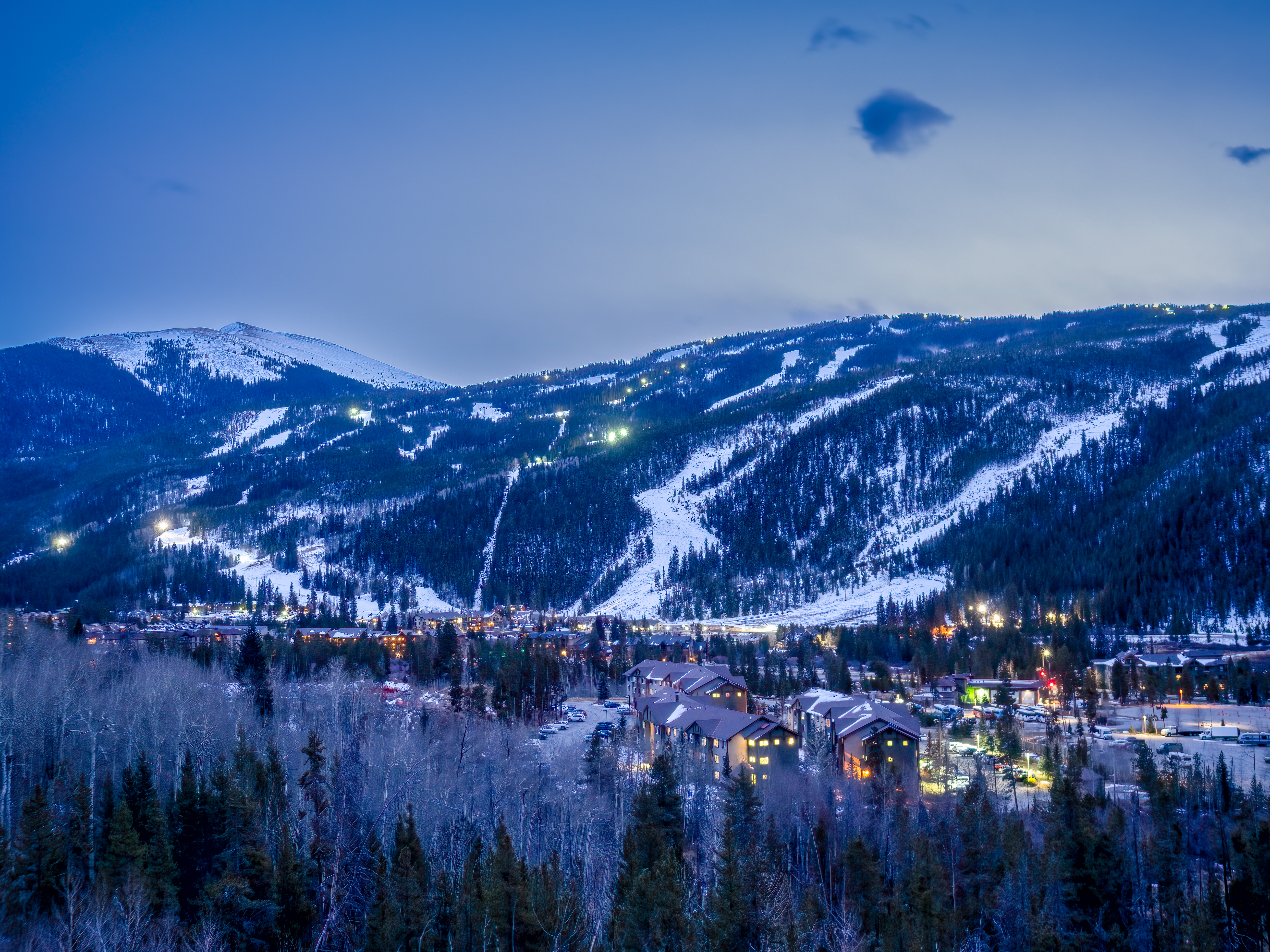 An image of Dercum mountain at night with lights in River Run Village. 