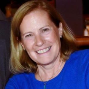 Photo of smiling woman in blue shirt.